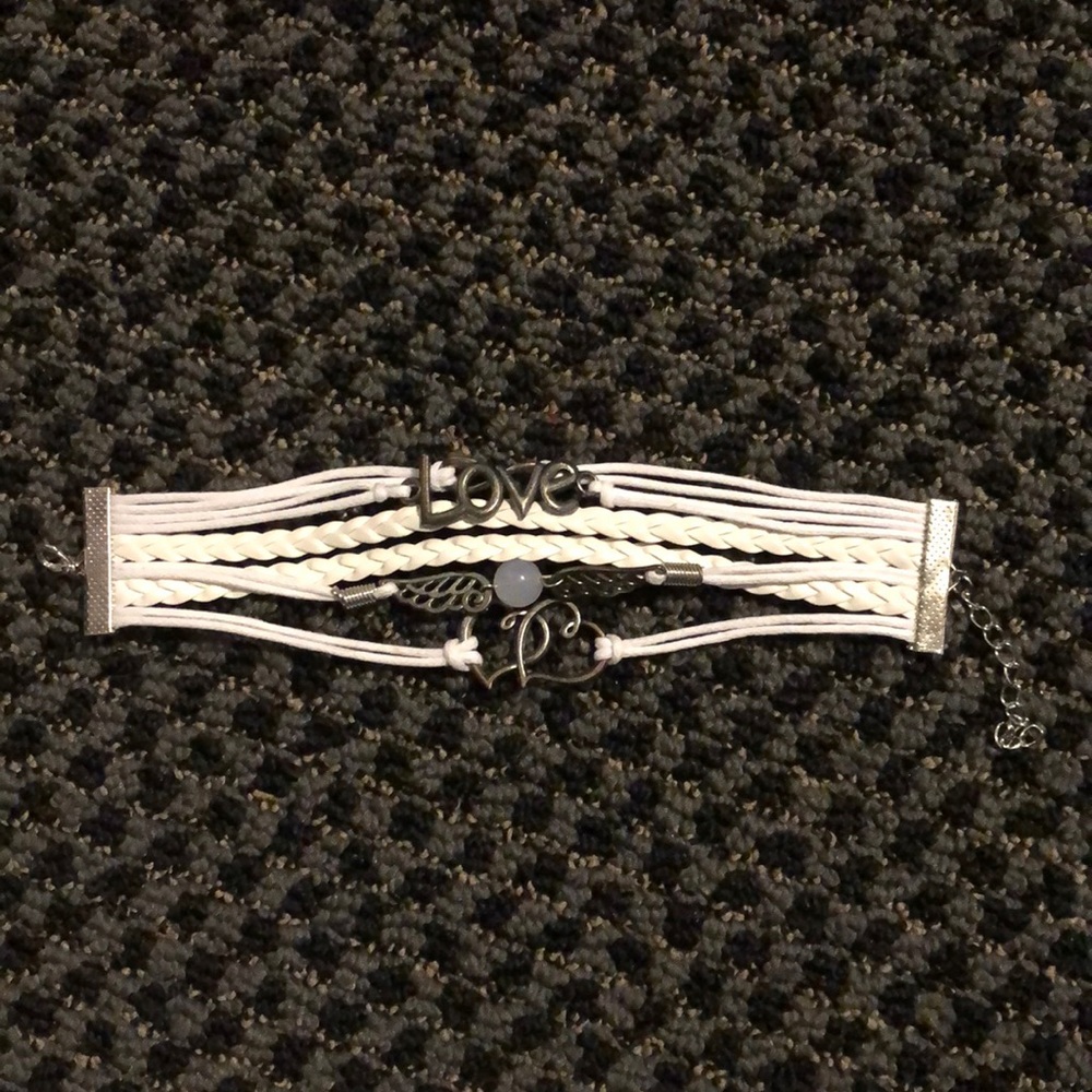 White, six strapped bracelet.